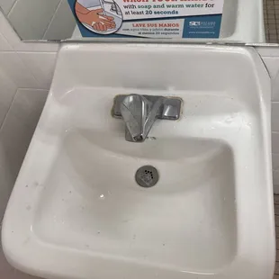 Filthy sink w/ ironic signage