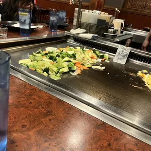 a large grill with vegetables on it