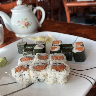 a plate of sushi and a teapot