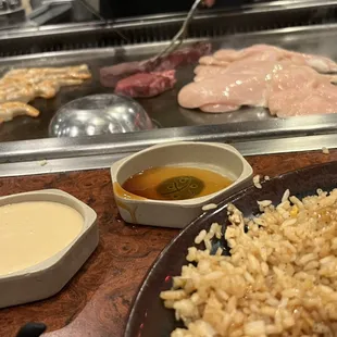 a plate of rice, meat, and dipping sauce