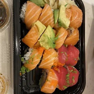 a tray of sushi and a cup of coffee