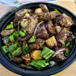 Steak and shishito peppers w/ baby corn, onion and white rice.