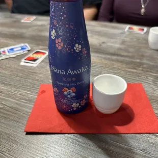 a bottle of water and a cup on a table