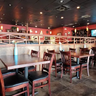 a dining area with tables and chairs