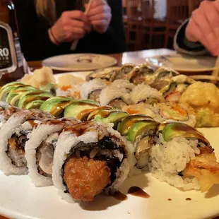 a plate of sushi and a bottle of beer