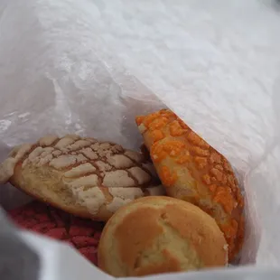 a variety of pastries in a paper bag