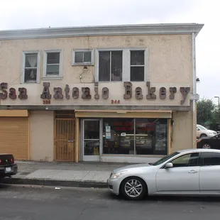 two cars parked in front of the building
