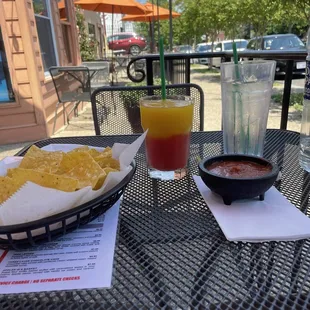 a plate of nachos and a drink