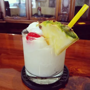 a pina cola with a pineapple garnish