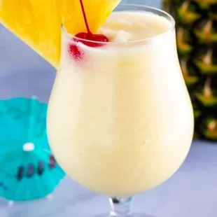 a pina cola with a pineapple garnish