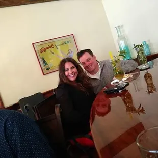 a man and a woman sitting at a bar