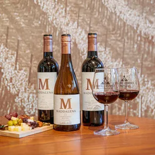 three bottles of wine and two glasses of wine