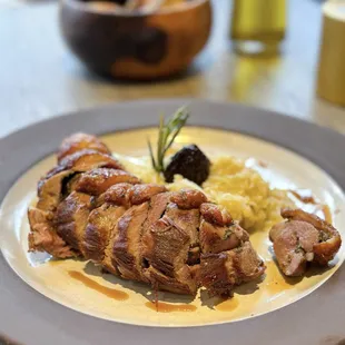 Duck breast cooked &quot;porchetta style&quot;, stuffed with herbs on top savoy cabbage puree and spiced figs