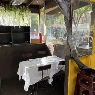 Our reserved table at the end of outdoor &quot;patio&quot; (Nr opening &amp; in 2/3&apos;s OPEN-AIR shed in foreground. TY for these pics &amp; Ur help, Mierco!)