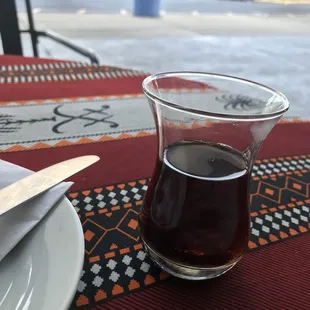 a glass of coffee on a table