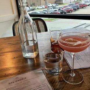 two glasses of wine and a bottle of wine