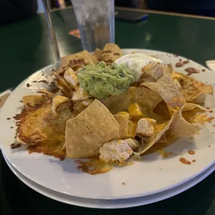 a plate of nachos with guacamole