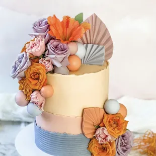 a cake decorated with flowers and seashells