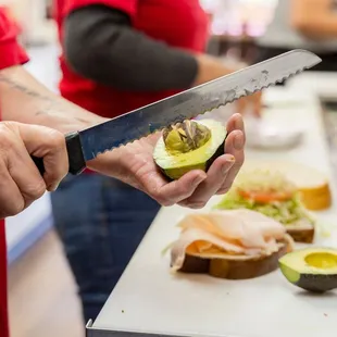 a person cutting an avocado