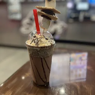 a drink with a straw hat on top