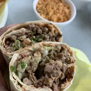 a hand holding a burrito