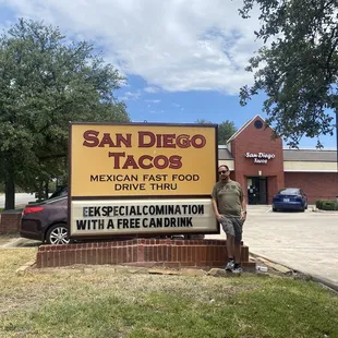 Husband posing with sign.