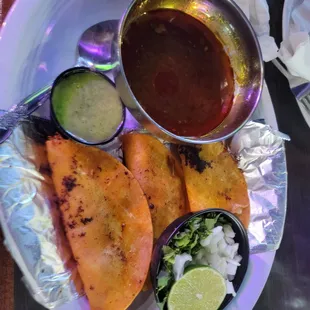 a plate of mexican food with sauces