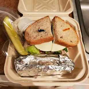 To go sandwich, wrapped veggies, and pickle