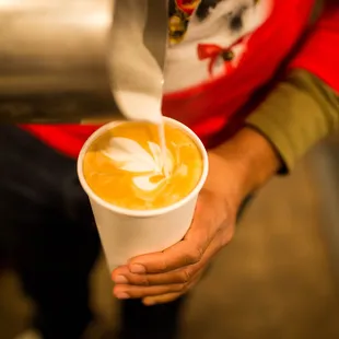 latte being poured into a cup