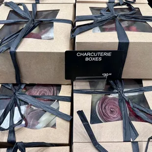 a variety of boxes wrapped in black ribbon