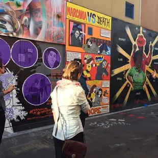 Discussing politically influential graffiti street art in the Mission on our Parks - Pints - Politics tour.