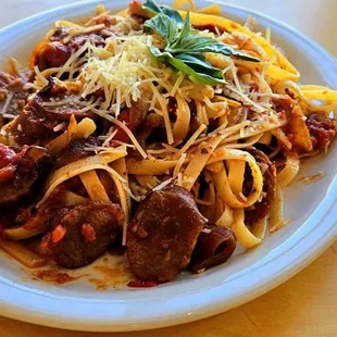 a plate of pasta and meat