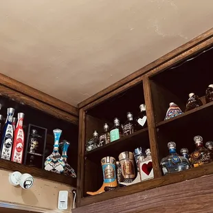 a shelf full of liquor bottles