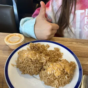 Fried rice ice with yum yum sauce on top.