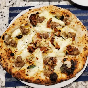 Panzarotta pizzal special, topped with crumbled potato croquette and Italian sausage.