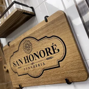 a wooden sign hanging on a wall