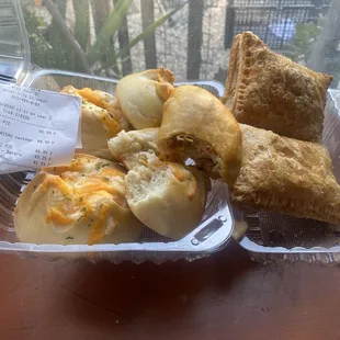 Cheesy garlic bread (l. 4/4.99), empanada (m. 3.25) puff mini pies (R. 2/5.99)