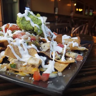 santiago nachos black beans, cheddar &amp; pepper jack, pico de gallo, feta, jalapenos, sour cream, guacamole, marinated grilled chicken.