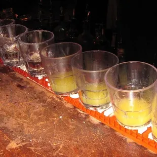 Straight vodka shots (left), and pineapple juice (?) (right)
