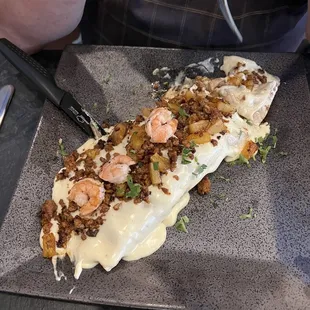 A flavor extravaganza!  Shrimp and chorizo outside, chicken and (I think) beef on the inside!  He couldn't say enough about the flavor!