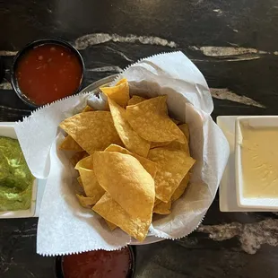 Cheese Dip, chips, salsa and guacamole.