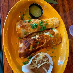 three quesadillas on a yellow plate