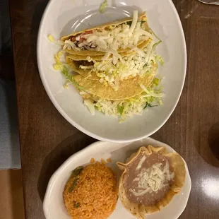 Combination platter three tacos with rice and beans