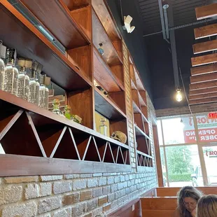 This divides the space there are more tables and the bar on the other side of the wall