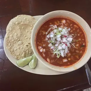 a bowl of chili and a tortilla