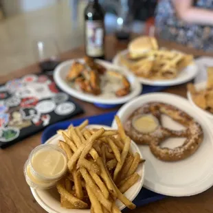 a plate of french fries and a plate of donuts