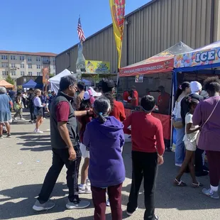 Food booths sell carnival/state fair type eats: funnel cakes, sausages.