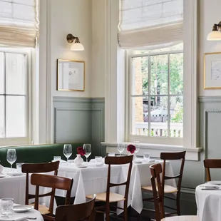 tables and chairs with white tablecloths