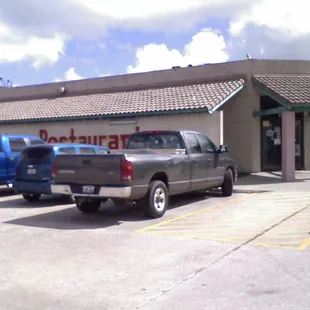 two trucks parked in front of the restaurant