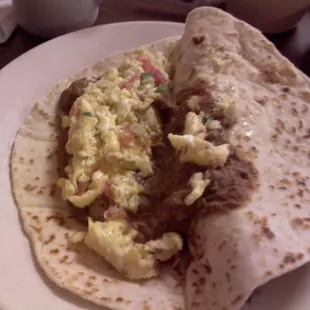 Eggs a la Mexicana with beans in a flour tortilla